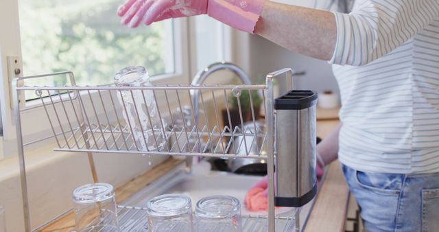 Woman Washing and Drying Glass Jars in Kitchen - Download Free Stock Images Pikwizard.com