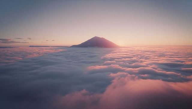 Solitary Mountain Peak Above Dreamy Sunrise Cloudscape