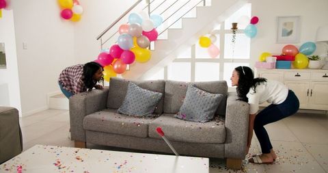 Women preparing for celebration in colorful living room