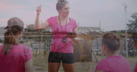 Fitness coach instructing team outdoors with passion and enthusiasm