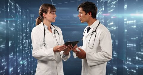 Healthcare Professionals Discussing Digital Tablet in Futuristic Setting