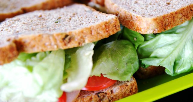Fresh vegetables peek out from between slices of whole grain bread in a healthy sandwich, with copy space. A focus on nutritious eating is evident in the choice of ingredients for this simple yet wholesome meal.