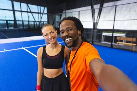 Athletic Coach and Player Taking Selfie on Indoor Tennis Court