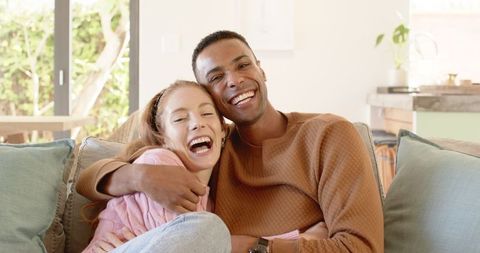 Joyful Diverse Couple Laughing Together at Home