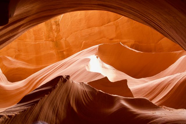 Showcasing the intricate curves and patterns of sandstone in Antelope Canyon, this image captures the natural beauty and geological wonder of the canyon's formations. Ideal for use in travel brochures, geographical studies, wall art prints for nature enthusiasts, and promotional material for southwestern USA tourism.