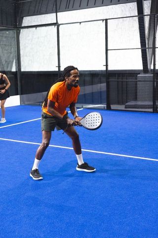 Sports team padel training on blue court with rackets