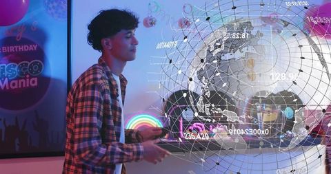 Young man exploring holographic globe at neon birthday party with futuristic ar projection