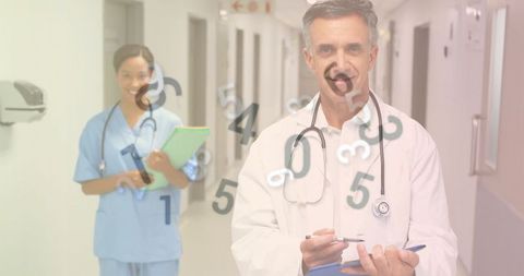 Doctor and Nurse Reviewing Medical Files in Hospital Corridor