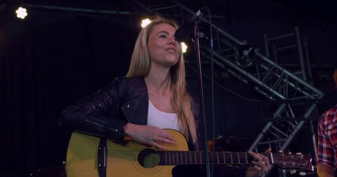 Caucasian Female Singer Rehearsing on Stage with Guitar - Download Free Stock Images Pikwizard.com