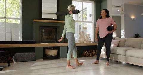 Senior Women Practicing Yoga Mindfulness Near Fireplace