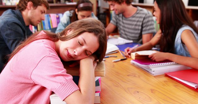 Tired Student Sleeping While Studying with Friends in Library - Download Free Stock Images Pikwizard.com