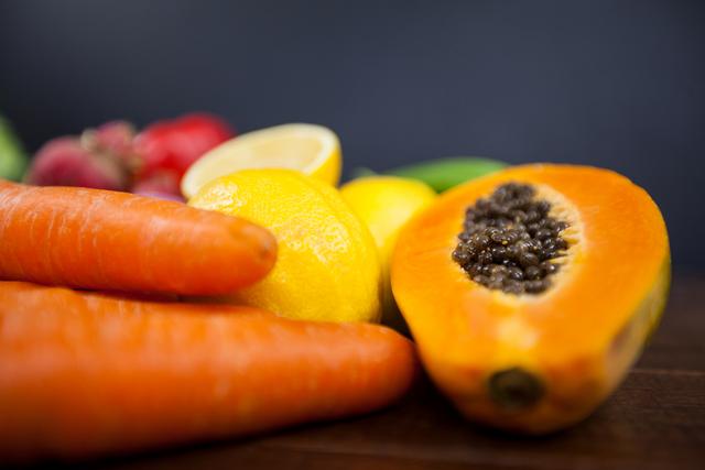 Close-Up of Fresh Vegetables and Tropical Fruits on Wooden Table - Download Free Stock Photos Pikwizard.com
