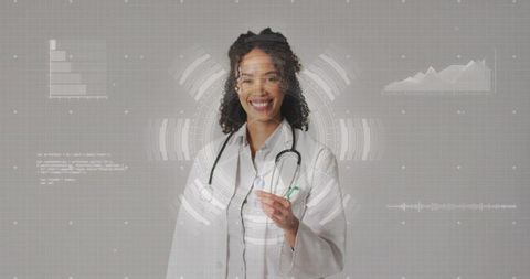 Smiling female doctor presenting virtual health interface holding pen and stethoscope