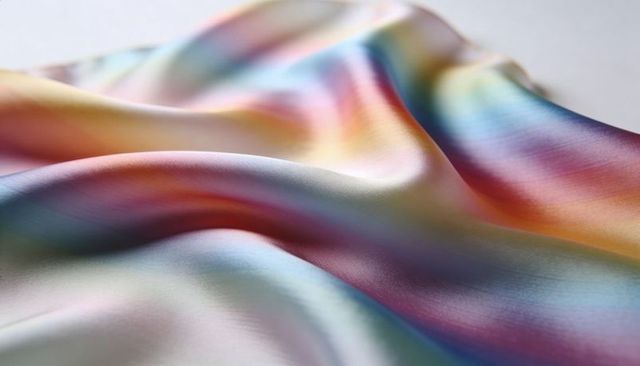 Shimmering iridescent satin drapery with pastel sheen and smooth sculpted folds