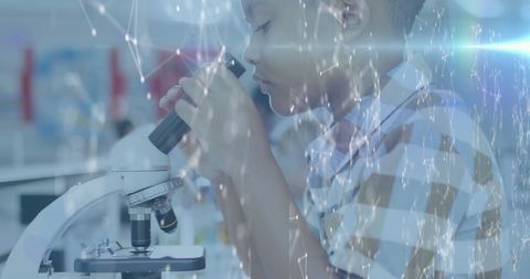 Curious child exploring microscope with digital network overlay