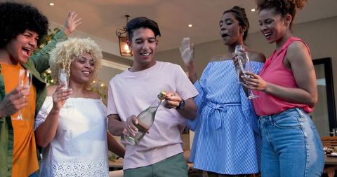 Diverse friends celebrating with champagne during outdoor party
