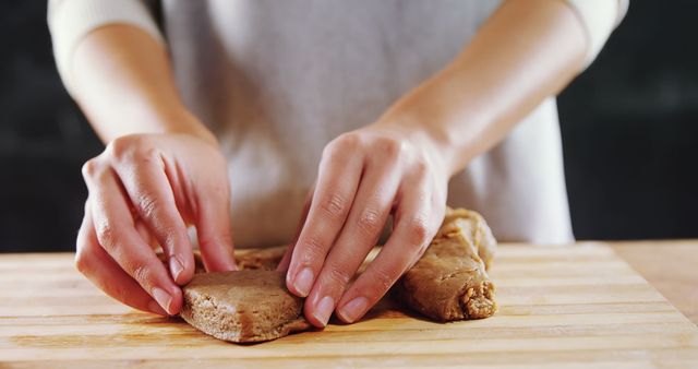 Mid section of woman molding gingerbread dough on wooden board  - Download Free Stock Photos Pikwizard.com
