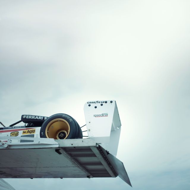 Rear Wing and Tire of Vintage Formula 1 Racing Car against Cloudy Sky - Download Free Stock Images Pikwizard.com