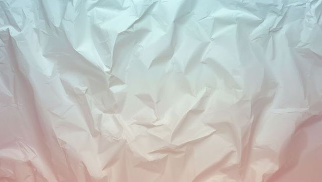 Crinkled paper with soft cyan to coral gradient