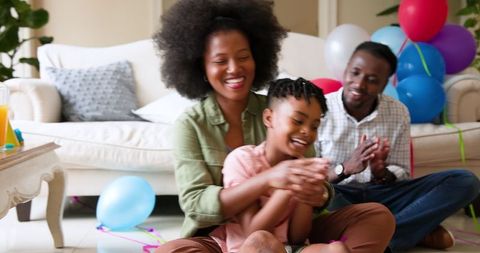 Joyful Family Celebrating Son's Birthday with Confetti at Home