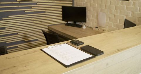 Modern reception desk with clipboard and tech devices
