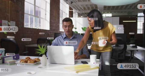 Coworkers Analyzing Social Media Impact at Modern Office Desk