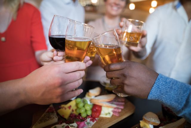 Close-up of friends toasting drinks in restaurant