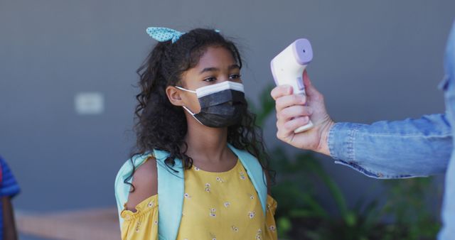 Girl Wearing Mask Getting Temperature Checked Before School - Download Free Stock Images Pikwizard.com