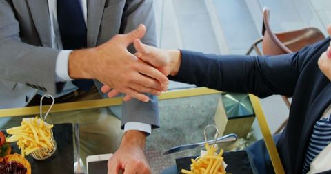 Business Partnership Established with Handshake at Lunch Meeting