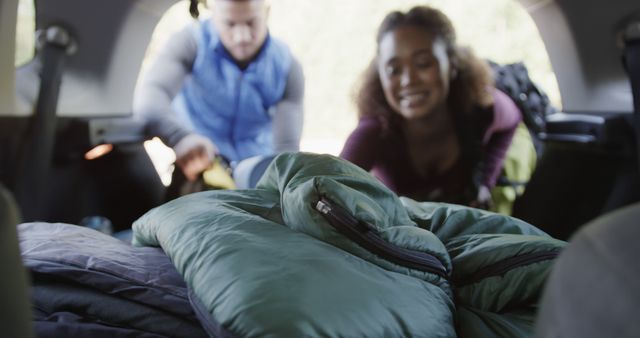 Couple Preparing for Outdoor Camping Trip by Loading Sleeping Bags in Car - Download Free Stock Images Pikwizard.com