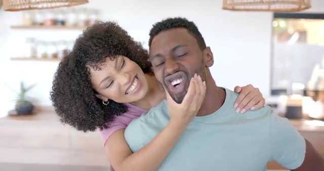 Couple sharing a tender and joyful moment with laughter in a modern kitchen. This vibrant and emotive scene highlights themes of love, togetherness, and happiness. Perfect for ad campaigns, lifestyle blogs, or articles focusing on relationships and joyful everyday moments.