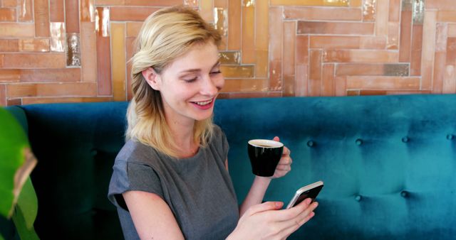 Smiling Woman Relaxing at Cafe with Coffee and Smartphone - Download Free Stock Images Pikwizard.com