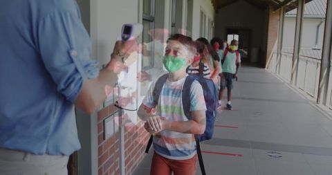 Children observing safety measures at school with visible virus overlay