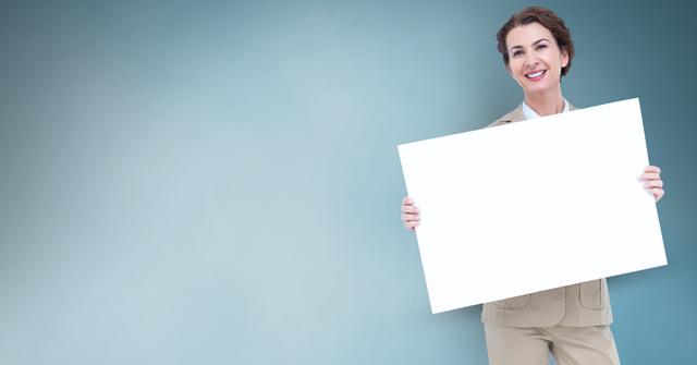 Smiling Businesswoman Holding Blank Billboard with Blue Background - Download Free Stock Photos Pikwizard.com