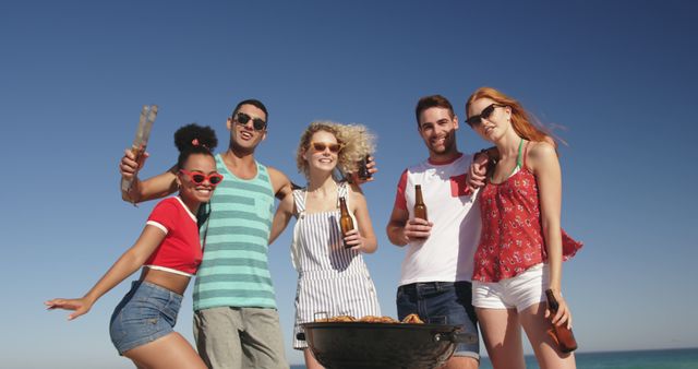 Friends Enjoying Beach BBQ Under Clear Blue Sky - Download Free Stock Images Pikwizard.com