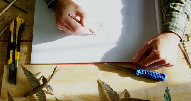 Person Drawing Architectural Sketch on Desk with Tools and Designs - Download Free Stock Images Pikwizard.com