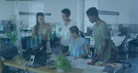 Diverse women collaborating on financial analytics and strategic planning in modern office