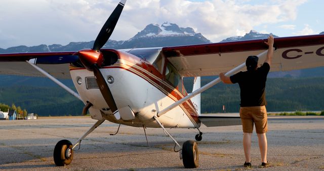 Pilot Preparing Small Aircraft for Flight at Remote Mountain Airstrip - Download Free Stock Images Pikwizard.com