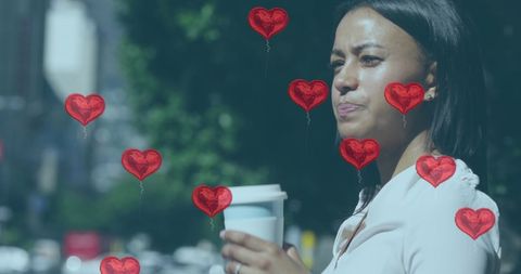 Woman Holding Coffee with Heart Balloons Overlaid