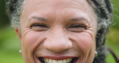Joyful Senior Woman Laughing in Natural Outdoor Setting