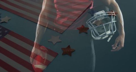 American Football Player Holding Helmet Above Patriotic Flags