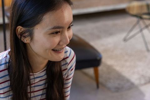 Young Woman Relaxing in Contemporary Living Room, Cozy Ambiance