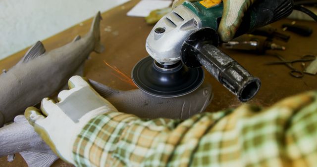 Craftsman Polishing Wooden Fish Sculpture with Angle Grinder - Download Free Stock Images Pikwizard.com