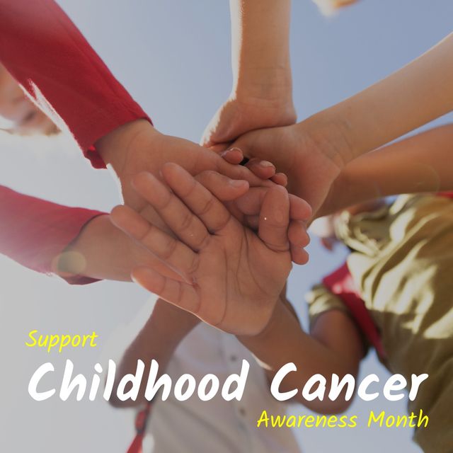 Photo shows multiracial children stacking hands, symbolizing unity and support for Childhood Cancer Awareness Month. Can be used for awareness campaigns, healthcare initiatives, charity events, community drives, and social media posts aiming to support and bring attention to childhood cancer.