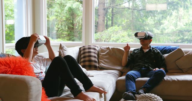 Two Kids Using Virtual Reality Headsets Relaxing in Living Room - Download Free Stock Images Pikwizard.com