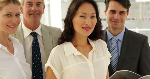 Diverse Business Team Smiling Confidently in Modern Office - Download Free Stock Images Pikwizard.com
