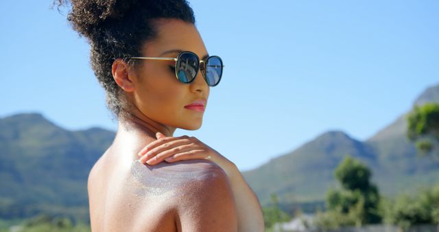 Woman Applying Sunscreen Outdoors on a Sunny Day - Download Free Stock Images Pikwizard.com