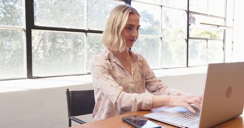 Businesswoman Efficiently Multitasking in Bright Office Setting