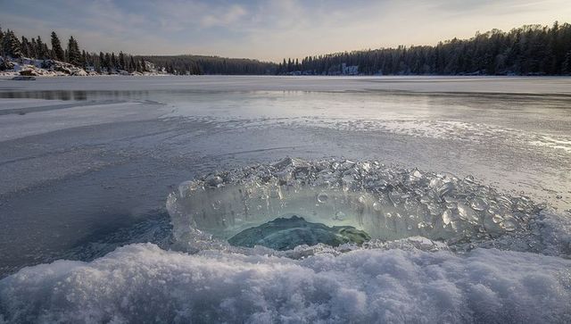 Circular Ice Hole with Frozen Lake Winter Landscape