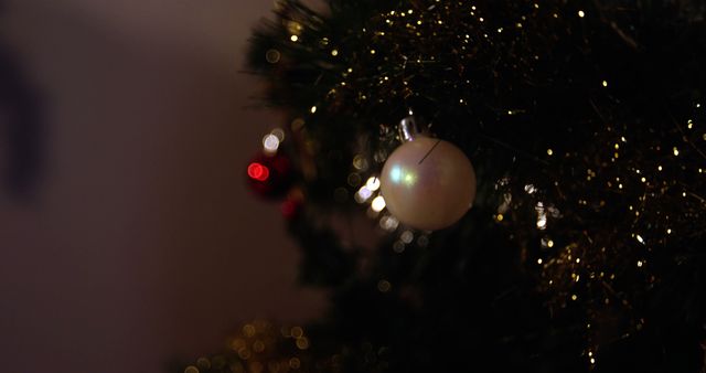 A close-up view of a Christmas tree ornament with soft glowing lights in the background, with copy space. Festive decorations like these add warmth and holiday spirit to a home or event during the Christmas season.